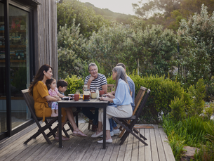 Family sitting at outdoor table